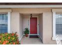 Inviting front entrance with a red door, potted plant, and manicured landscaping at 4116 43Rd W Ave, Bradenton, FL 34205