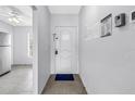 Bright entrance hallway featuring tile flooring and ample natural light from a nearby window at 4116 43Rd W Ave, Bradenton, FL 34205