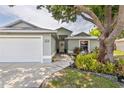 Inviting home with a two-car garage, lush lawn, and attractive landscaping surrounding the front entrance at 4222 Lanai Dr, Sarasota, FL 34241