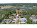 Aerial view showcasing the home's location near a golf course, lakes, and lush greenery at 435 Whispering Oaks Ct, Sarasota, FL 34232