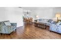 Inviting living room featuring hardwood floors, neutral decor, and ample natural light at 435 Whispering Oaks Ct, Sarasota, FL 34232