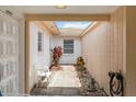 Front door leads to a bright entryway with courtyard, adding charm and natural light at 5062 White Oak Ct, Bradenton, FL 34207