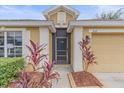 Front entrance showcasing beautiful landscaping and stylish architectural details at 5618 Sheer Bliss Loop, Land O Lakes, FL 34639