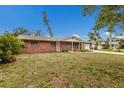 Traditional brick home with a classic design and a neatly kept lawn, showcasing suburban charm at 7803 2Nd W Ave, Bradenton, FL 34209