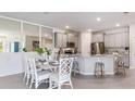 Bright, open kitchen boasts stainless steel appliances, stone countertops, and a breakfast bar with seating at 833 157Th E Ct, Bradenton, FL 34212