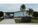 Charming single-story home with a covered parking area, palm trees, and landscaped front yard at 8531 Imperial Cir, Palmetto, FL 34221