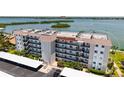 Multi-story condo building featuring covered parking, lush landscaping, and easy access to nearby waterways at 8897 Midnight Pass Rd # 407, Sarasota, FL 34242