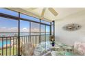 Charming dining space on the lanai with views of the pool and the sparkling Intracoastal waterway at 8897 Midnight Pass Rd # 407, Sarasota, FL 34242