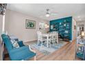 Bright dining room with stylish decor, featuring a modern table set and eye-catching blue accent wall at 951 Varet Rd, Venice, FL 34293