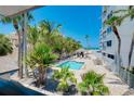Scenic view of the pool surrounded by lush palm trees and seating, perfect for relaxation at 1001 Point Of Rocks Rd # 207, Sarasota, FL 34242