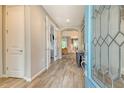 Bright and airy foyer with wood-look tile flooring, archways, and a decorative glass front door at 11502 Golden Bay Pl, Bradenton, FL 34211