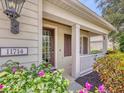 Inviting front porch with elegant architectural details and lush, colorful landscaping at 11714 Forest Park Cir, Bradenton, FL 34211