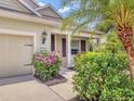 Charming front porch featuring manicured landscaping and a well-lit entryway at 11714 Forest Park Cir, Bradenton, FL 34211