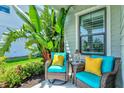 Inviting porch with comfortable seating amidst lush greenery, creating a cozy outdoor space at 13849 Old Creek Ct, Parrish, FL 34219