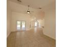 Open-concept living room boasting tile flooring and access to the screened lanai at 1422 Jakway Rd, North Port, FL 34288