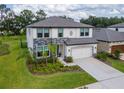 Charming two-story home features stone accents, a two-car garage, and a beautifully landscaped front yard at 14787 Gallop Run Dr, Lithia, FL 33547