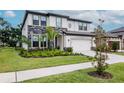 Charming two-story home features stone accents, a two-car garage, and a beautifully landscaped front yard at 14787 Gallop Run Dr, Lithia, FL 33547