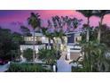 Aerial view of a contemporary home surrounded by mature trees and vibrant landscaping at 1607 Flower Dr, Sarasota, FL 34239