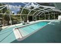 Beautiful backyard pool area with a screened enclosure and an outdoor seating area with lounge chairs at 2159 Constitution Blvd, Sarasota, FL 34231