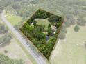 An aerial view showcasing the property boundaries, nestled amidst lush greenery at 22063 Lake Lindsey Rd, Brooksville, FL 34601