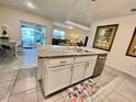 Bright kitchen with island, granite countertops, stainless steel appliances, and pendant lighting at 2410 Mizner Bay Ave, Bradenton, FL 34208