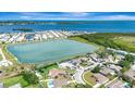 Stunning aerial view showcasing a waterfront home with a pool in a charming neighborhood at 2420 16Th W St, Palmetto, FL 34221