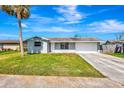Inviting single-story home with a lush green lawn and a convenient two-car garage at 2420 16Th W St, Palmetto, FL 34221