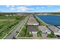 An aerial view of homes along the lakefront featuring lush landscaping and well-maintained streets at 26000 Seastone Dr, Englewood, FL 34223