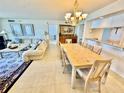 Comfortable living area with an adjacent dining area and a bar at 2675 Gulf Of Mexico Dr # 203, Longboat Key, FL 34228