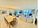 Open-concept living room featuring tile floors, dining area, and beach views at 2675 Gulf Of Mexico Dr # 203, Longboat Key, FL 34228