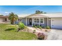 Inviting single-story home showcasing a beautifully landscaped front yard and covered entryway, enhancing its curb appeal at 2801 21St W Ave, Bradenton, FL 34205