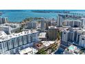 Aerial view of buildings and cityscapes overlooking a body of water with boats and islands at 33 S Gulfstream Ave # 306, Sarasota, FL 34236