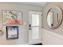 Entryway of home with a white door, wall art, mirror, and wainscoting at 33 S Gulfstream Ave # 306, Sarasota, FL 34236