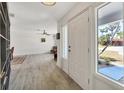 Bright foyer featuring tile floors, a large front window, and views of the living area at 3426 Brookline Dr, Sarasota, FL 34239