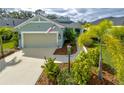 Beautiful single-story home with lush landscaping, well-maintained lawn, and a two-car garage at 3631 Shimmering Oaks Dr, Parrish, FL 34219