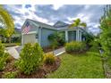 Inviting single-story home with tropical landscaping, green lawn, and attached two-car garage at 3631 Shimmering Oaks Dr, Parrish, FL 34219