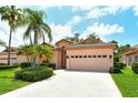 Attractive home featuring a tile roof and meticulously maintained lawn at 3804 Amapola Ln, Sarasota, FL 34238