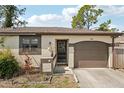 Close-up of home showcasing a welcoming front door, attached garage, and neat landscaping at 3881 Holin Ln, North Port, FL 34287
