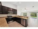 Modern kitchen features stainless steel appliances, granite countertops, and ample cabinet space at 4091 Dull St, North Port, FL 34286