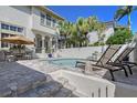 Beautiful backyard pool area with an umbrella-covered dining table and lounge chairs at 4108 Roberts Point Rd, Sarasota, FL 34242
