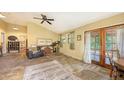 The open living room has a high ceiling, ample sunlight, and French doors at 4122 Old Bradenton Rd, Sarasota, FL 34234