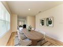 Bright dining room featuring a wooden table with white chairs and stylish modern art at 4206 Park Willow Ave, Palmetto, FL 34221