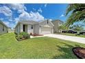 Inviting single-story home with a manicured lawn, partial landscaping and a two-car garage with a clean driveway at 4206 Park Willow Ave, Palmetto, FL 34221