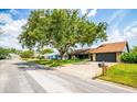 A single-story home with stone accents sits along a paved residential street at 4612 Masefield Pl, Sarasota, FL 34241