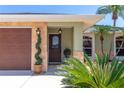 Inviting front entrance with well-maintained landscaping and a decorative glass front door at 4758 Breezy Pines Blvd, Sarasota, FL 34232