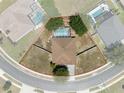 Aerial view showcasing property lines of home featuring a screened pool and surrounding landscaping at 4951 Brightstone Pl, Spring Hill, FL 34609
