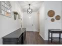 Bright foyer featuring dark wood floors, neutral walls, and decorative accents at 5020 Torrey Pines Run, Bradenton, FL 34211