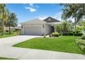 Inviting single-story residence with a well-kept yard, attached garage, and attractive landscaping at 5020 Torrey Pines Run, Bradenton, FL 34211