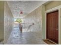 Condo hallway with unit door to the right and stairs/balcony in the distance at 5552 Bentgrass Dr # 7-301, Sarasota, FL 34235