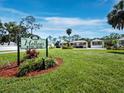 Welcome to The Hollows, a community of lovely townhomes surrounded by lush landscaping and mature trees at 6110 Country Club Way # 102, Sarasota, FL 34243